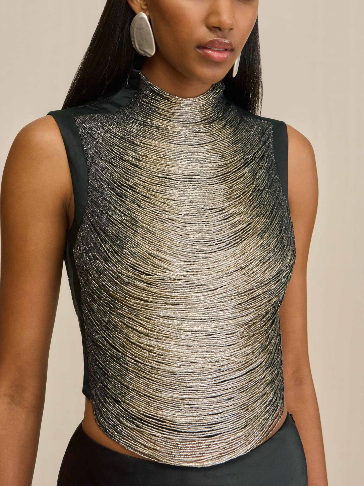 Elegant Black Ensemble: Sleeveless Fringe Top Paired with Flowing Satin Skirt