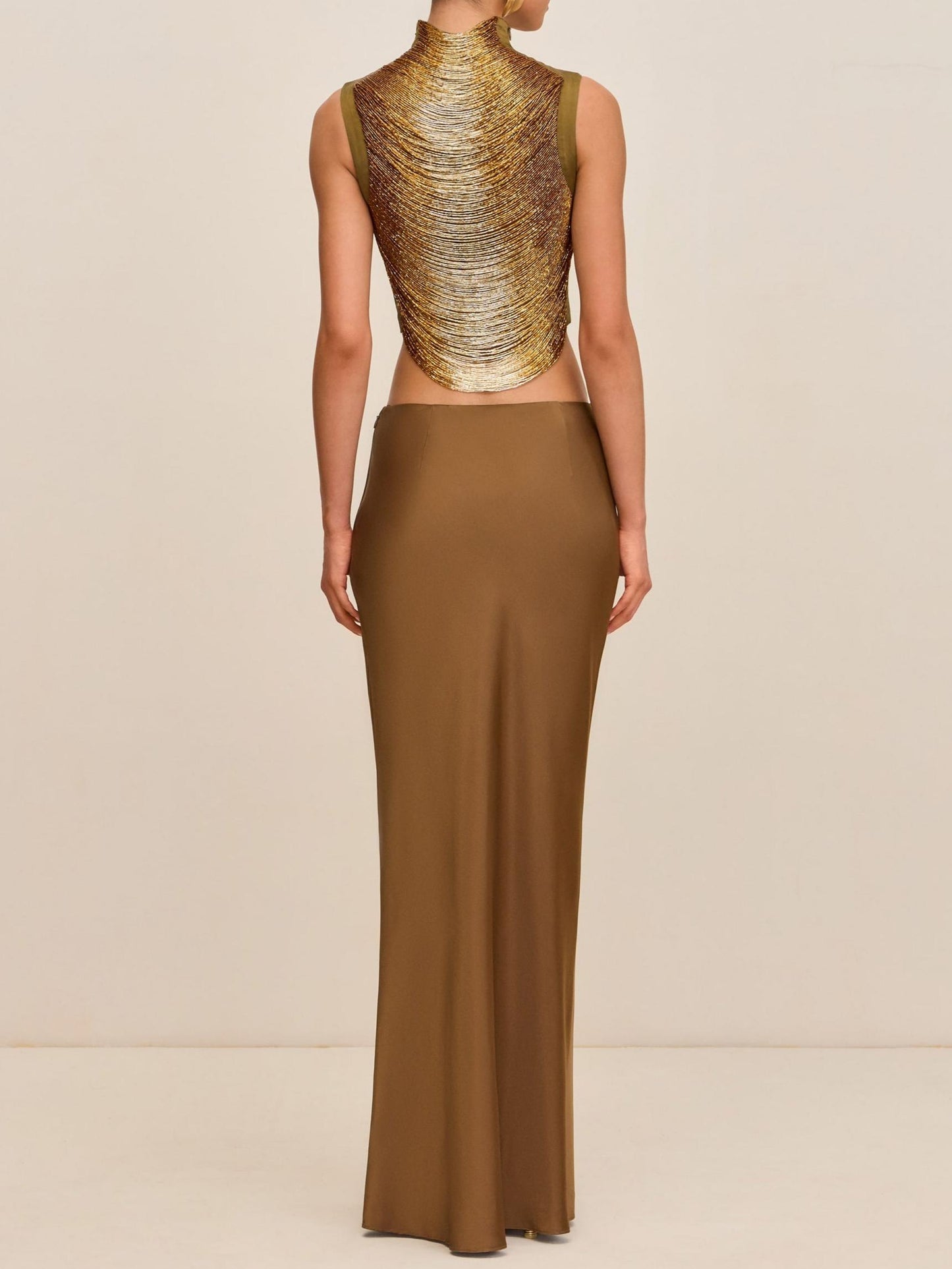 Elegant Bronze Ensemble: Sleeveless Fringe Top Paired with Flowing Satin Skirt